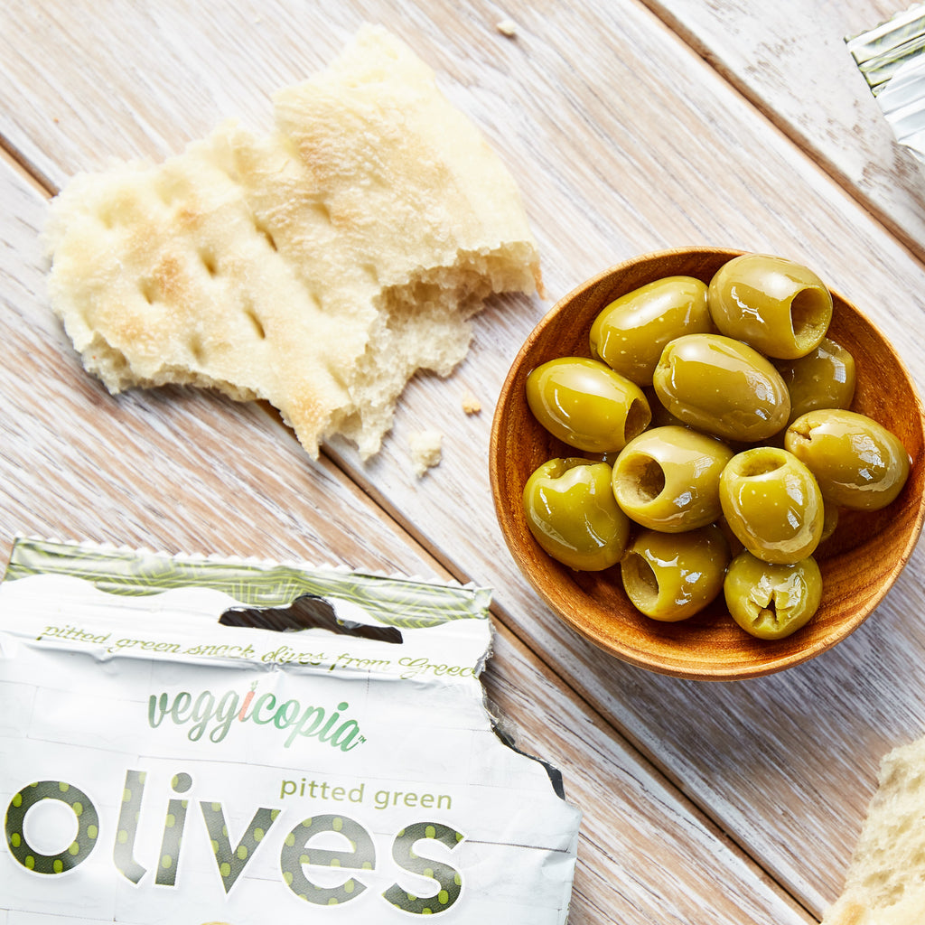 Snack olives by Veggicopia, with open package and olive in a bowl