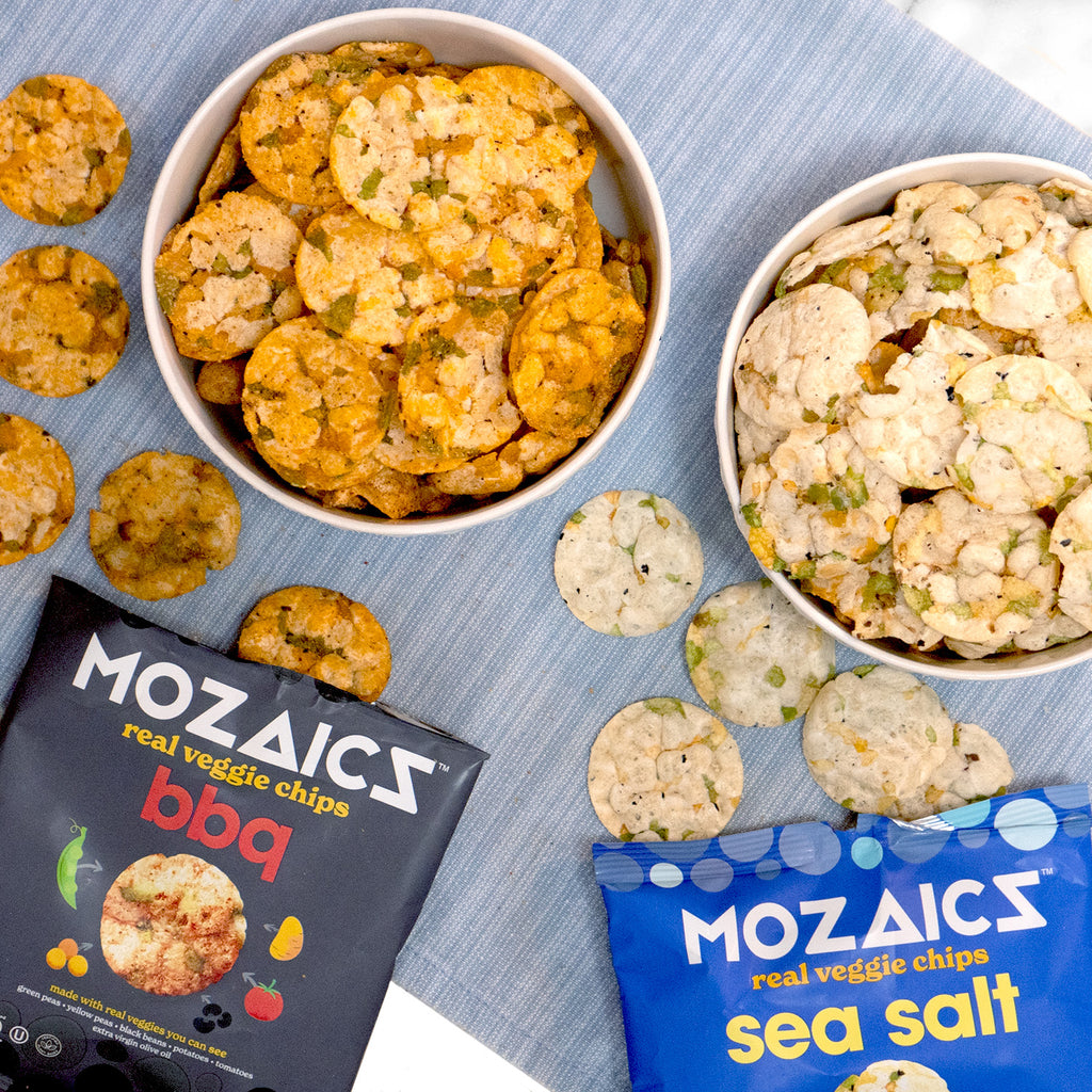 Healthy snack chips Mozaics Chips, packet of flavors in Sea Salt and BBQ on a table cloth with two bowls of Mozaics chips