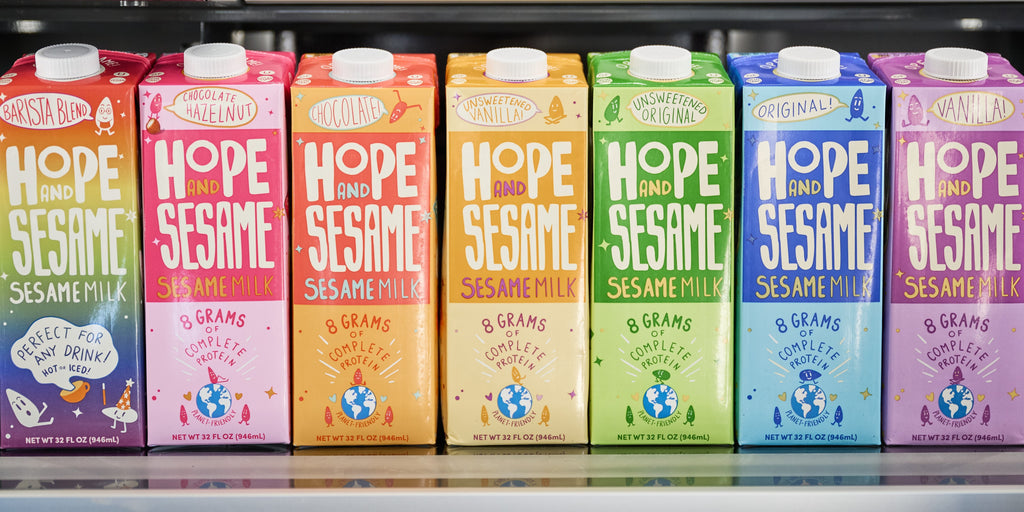 Dairy alternative Hope and Sesame Sesamemilk, picture of seven variety cartons on fridge shelf 
