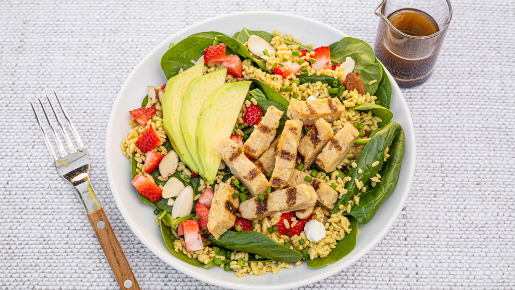 Rice alternative RightRice, bowl of Strawberry Spinach Salad with RightRice, chicken, avocado and strawberries 