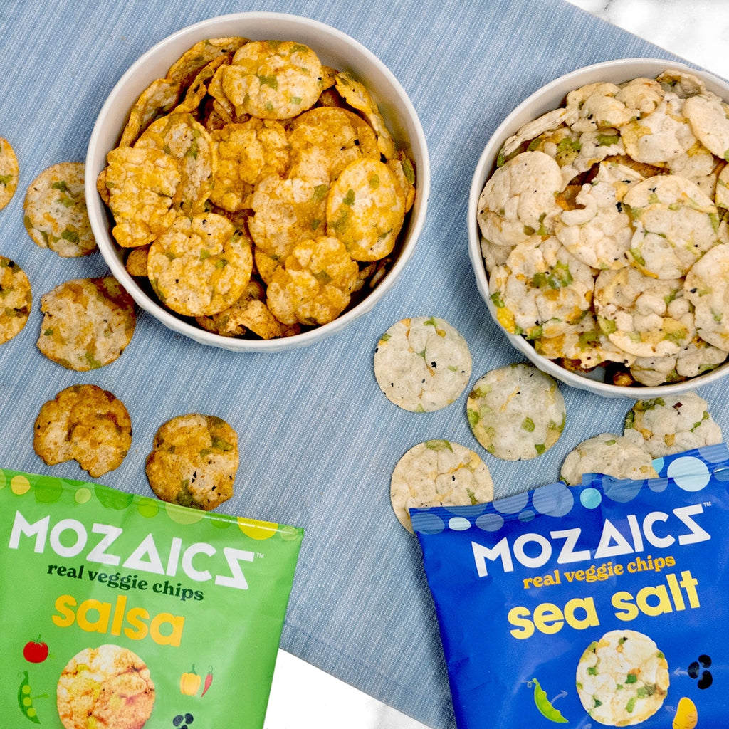 Healthy snack Mozaics Real Veggie Chips, packages of opened Mozaics Salsa and Sea Salt with two bowls full of Mozaics Chips