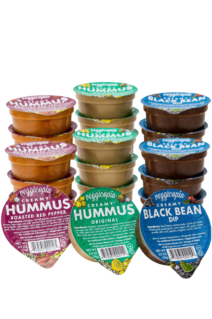 Snacks by Veggicopia, stacked containers of all three flavors, Creamy Hummus Roasted Red Pepper, Creamy Hummus Original and Creamy Black Bean Dip